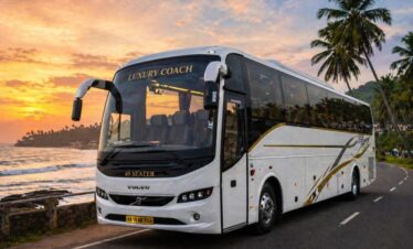 A 49-seater luxury coach parked near a scenic coastal road
